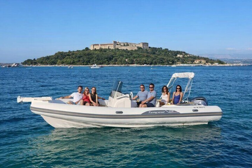 A boat with people on it, water, and a distant castle on a hill. 1