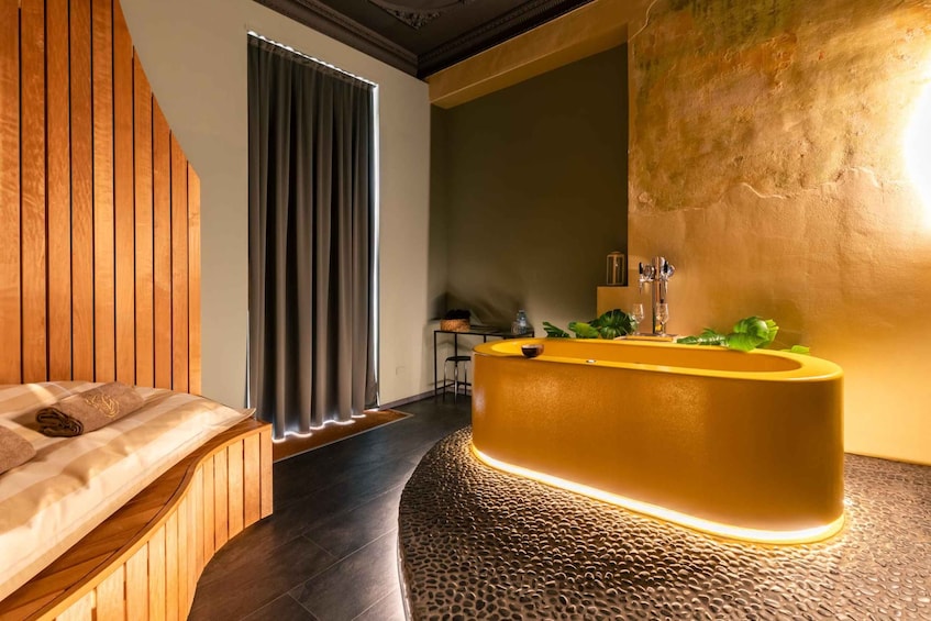 A modern bathroom with a wooden vanity, a bathtub, and a large mirror. 2