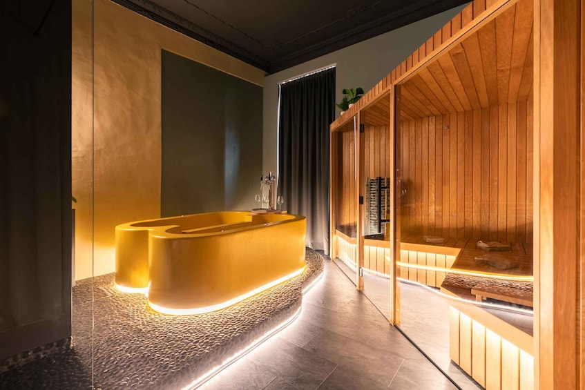 A modern spa with a wooden reception desk and a large, illuminated bathtub. 3