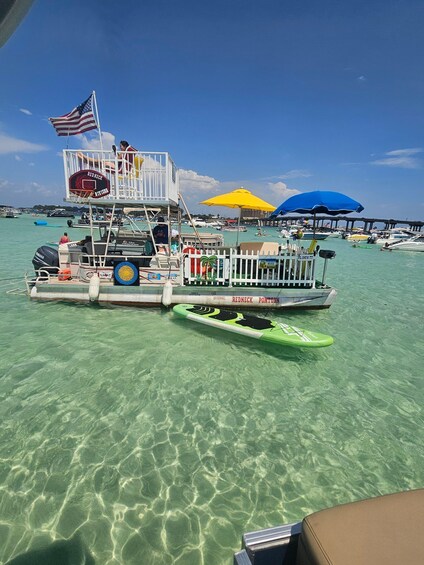 A boat with an American flag, a basketball hoop, and a lifeguard stand. 3
