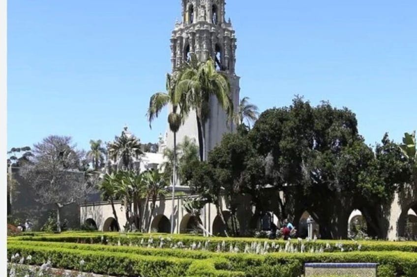 Une église historique dotée d’un clocher imposant, entourée de jardins bien entretenus et de palmiers. 2