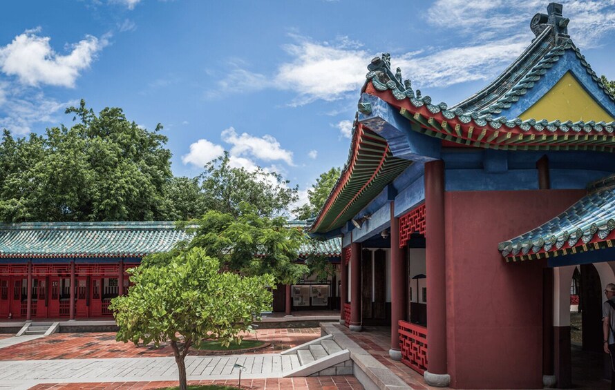 A traditional Chinese building with a blue roof and red columns. 2