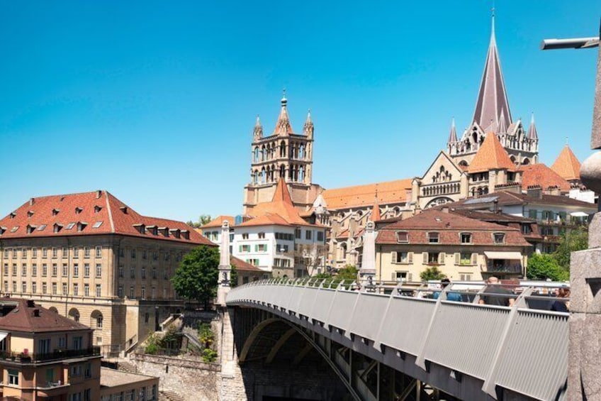 A bridge over a river, historic buildings, and a church with a tall spire. 2