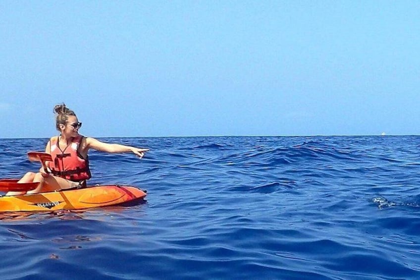 A person kayaking on a calm sea. 5