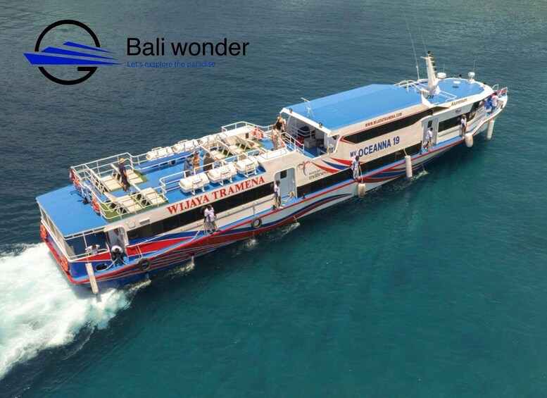 A large boat named 'WIJAYA TRAMENA' with 'MY OCEANNA 19' written on the side, sailing on clear blue water. 1