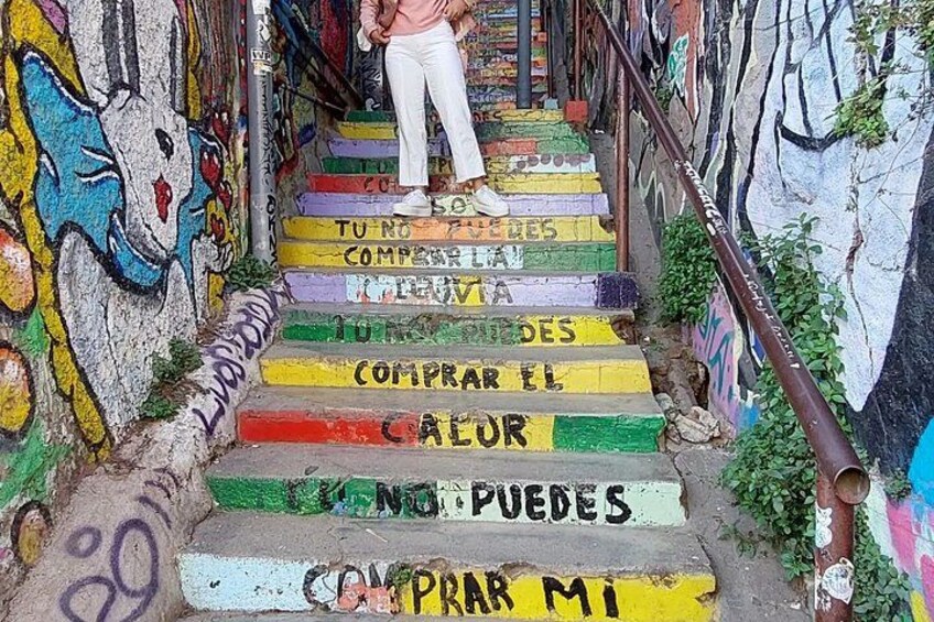A staircase with colorful steps and graffiti. 5