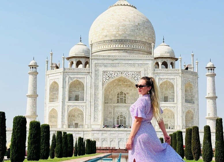 A person standing in front of the Taj Mahal. 1