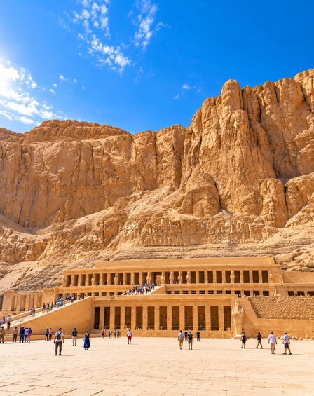 A large ancient Egyptian temple with visitors. 5