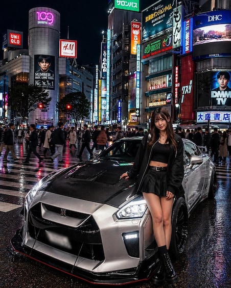 A city street at night with a woman posing next to a sports car, surrounded by illuminated billboards and signs. 1