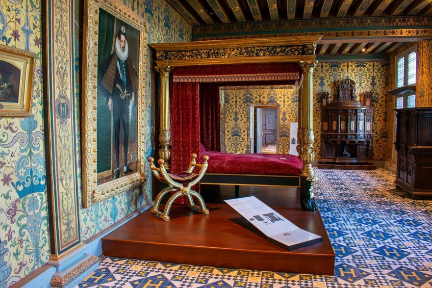 A richly decorated room with a four-poster bed, ornate furniture, and patterned walls. 5