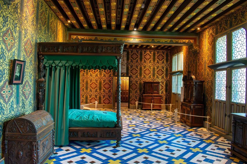 A room with a four-poster bed, ornate walls, and a patterned floor. 3