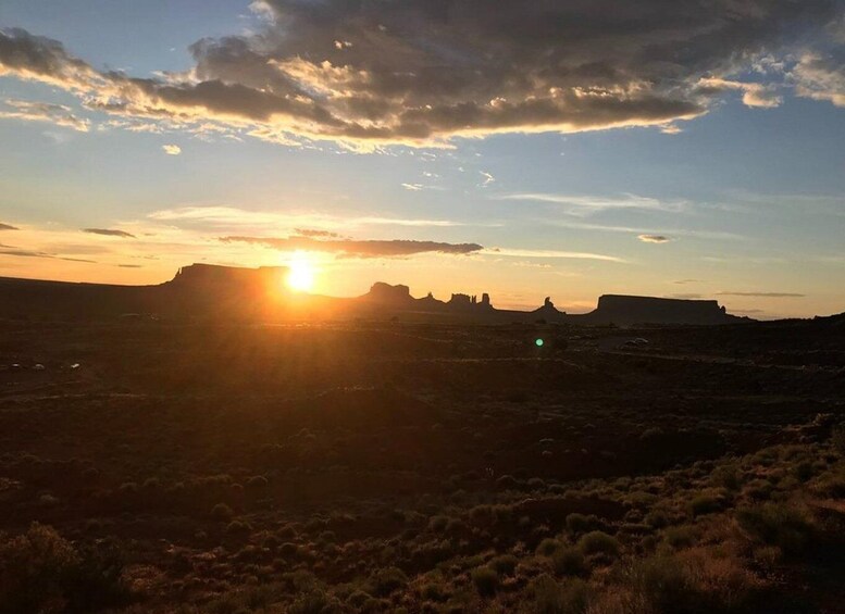 A sunset over a desert landscape with prominent rock formations. 4