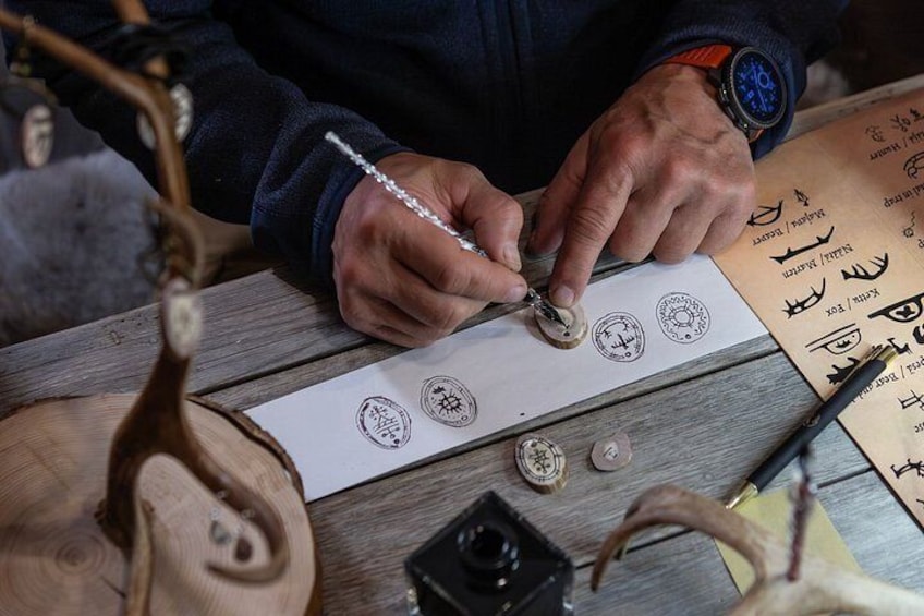 A person engraving a stamp on a wooden surface. 2
