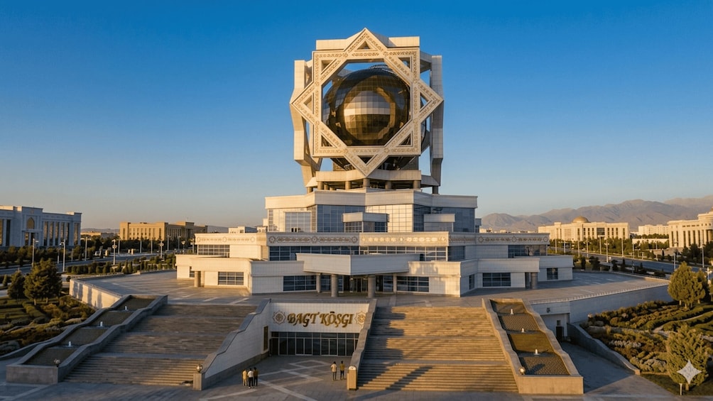A modern building with a large spherical glass dome, surrounded by a landscaped area with steps and pathways. 3