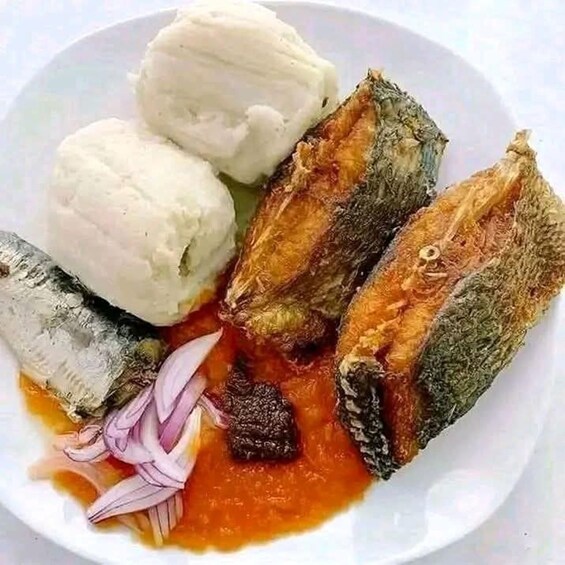 A plate with fish, a tomato-based sauce, and a white creamy substance. 3