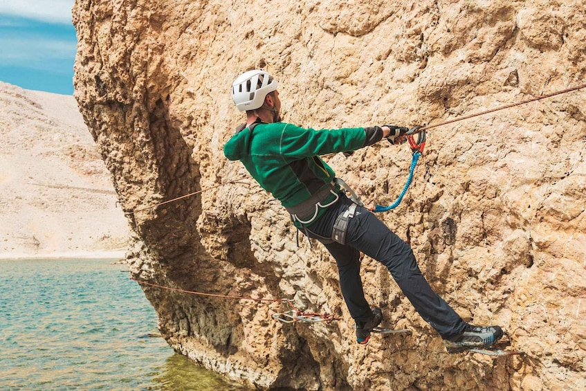 A person rock climbing on a cliff. 2