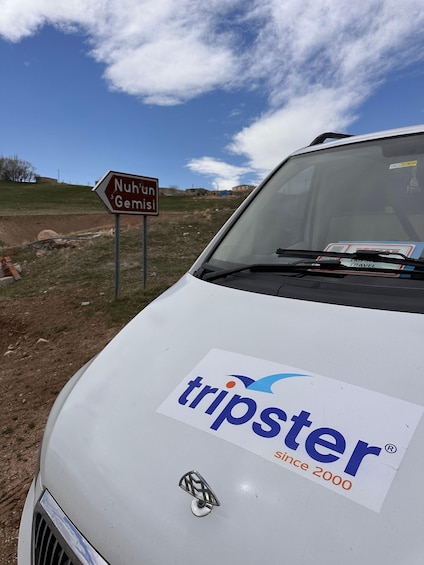 A white vehicle with a Tripster logo and a sign for Nuhun Gemisi. 4