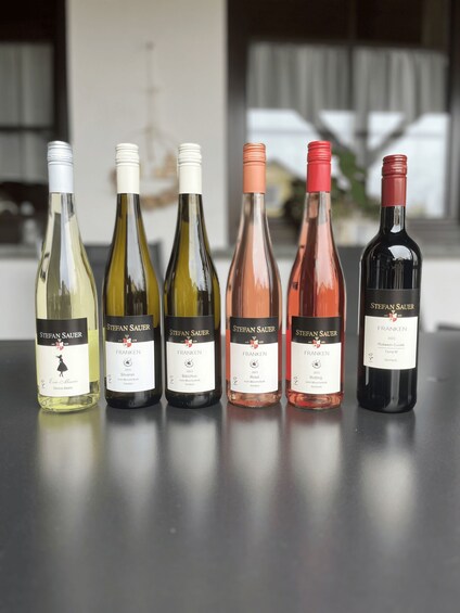 Six bottles of wine from Stefan Sauer, arranged on a table. 2