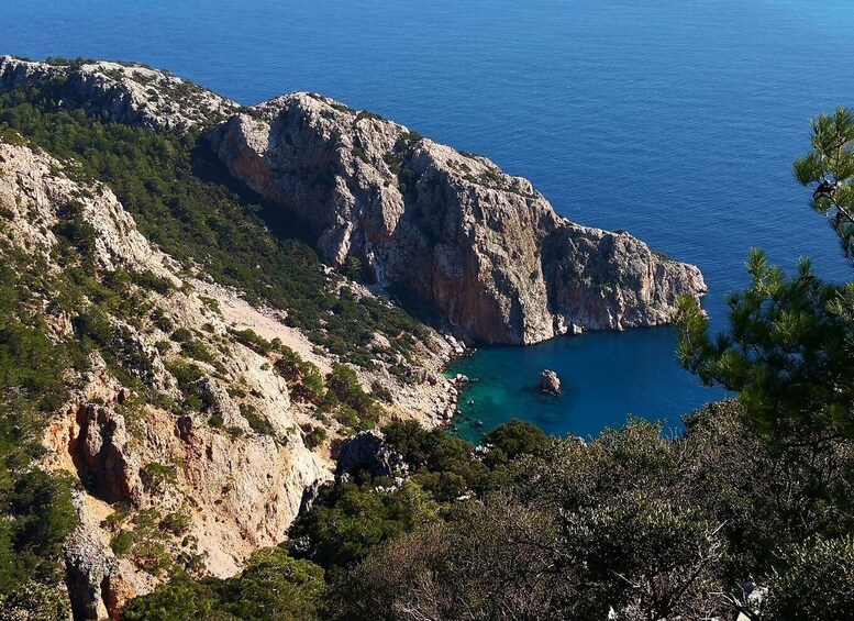 A rugged coastline with rocky cliffs and a clear blue sea. 3