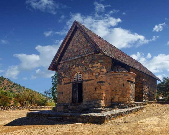A stone church with a triangular roof and a small porch. 1