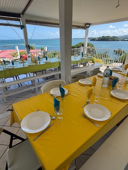 A table set for dining with a view of the ocean. 1