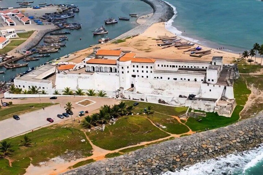 A coastal fort with a beach, a marina, and a rocky shoreline. 1