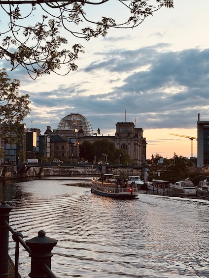 A river with boats, a bridge, and a large domed building in the background. 3