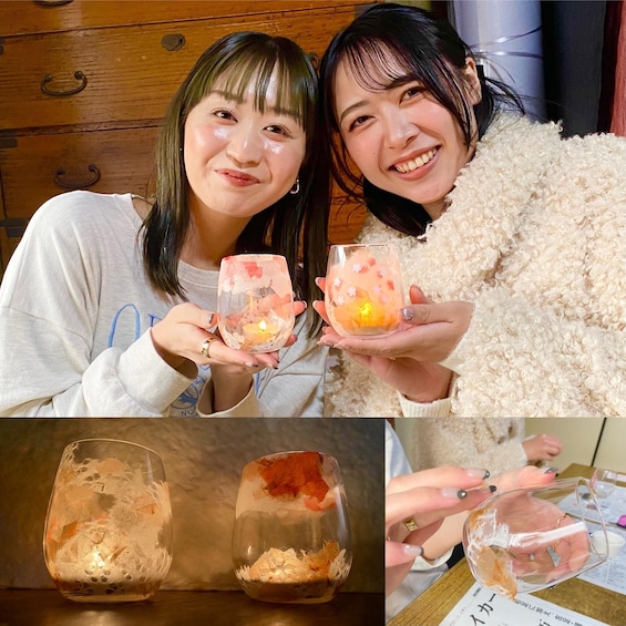 Two people holding glass containers with candles and dried flowers. 1