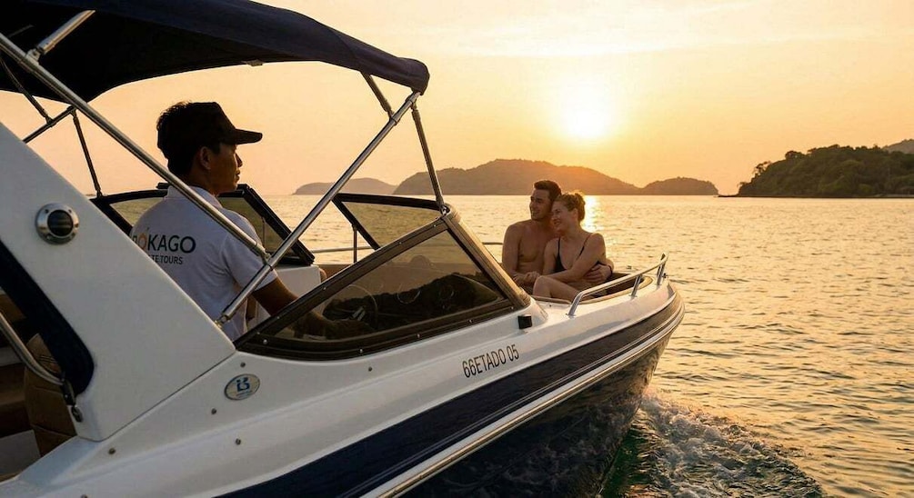 A boat with a person steering and two passengers on a calm body of water during sunset. 5