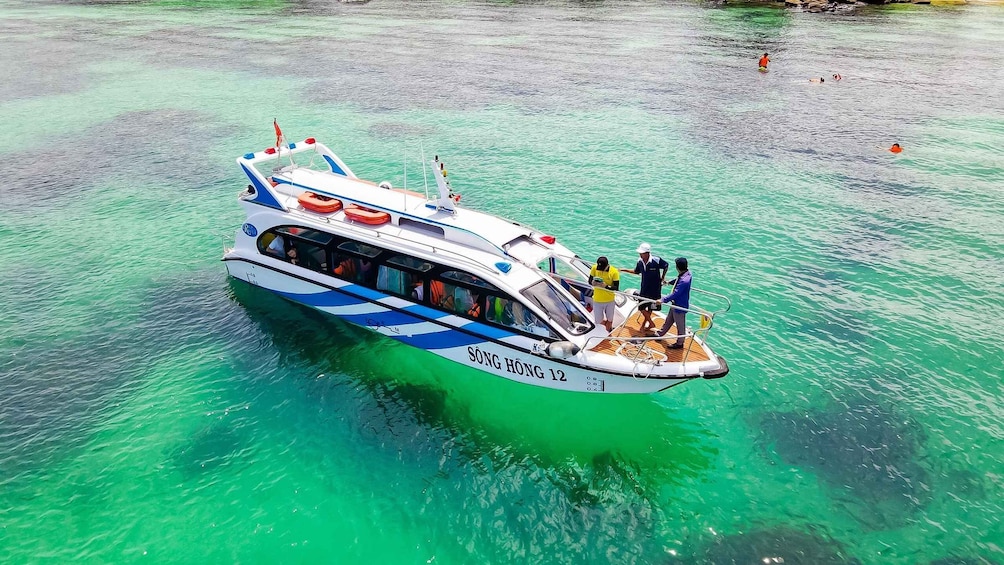 A boat named SÖNG HÖNG 12 on clear turquoise water. 1