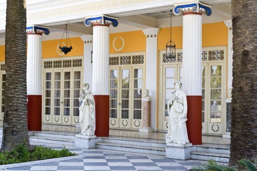 A building facade with columns, statues, and a checkered floor. 4