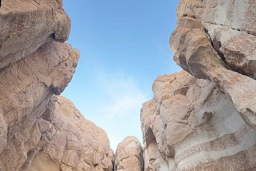 A canyon with layered rock formations and a clear sky. 5