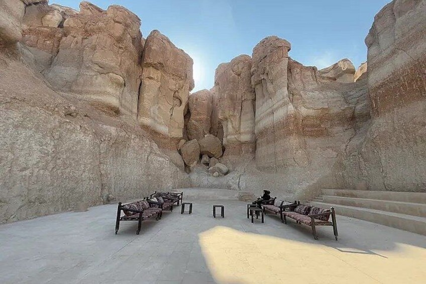 A canyon with rock formations and benches. 4