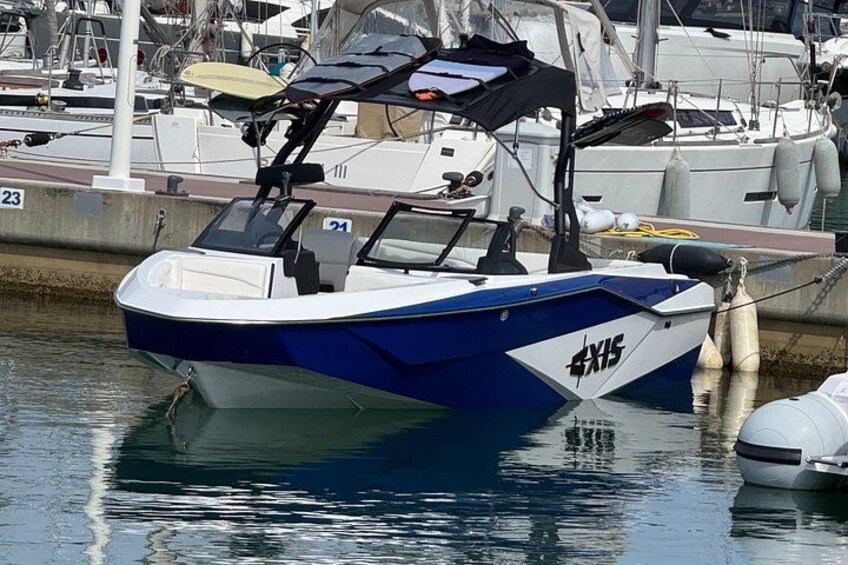 A blue and white boat with the number 21 docked at a marina. 1