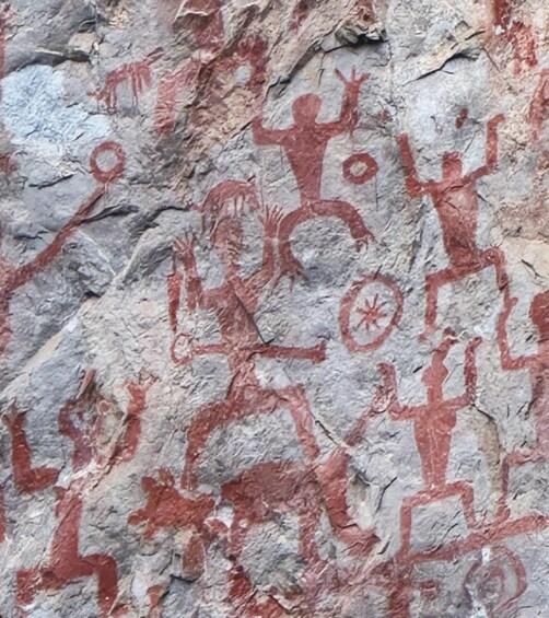 Ancient red rock paintings of human figures and symbols. 5