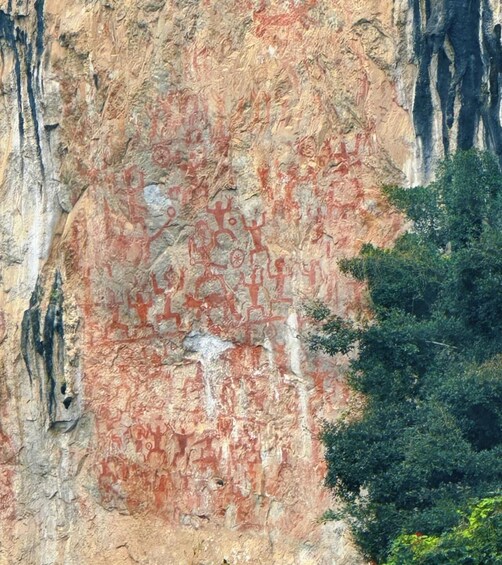 A rock face with ancient red petroglyphs. 2