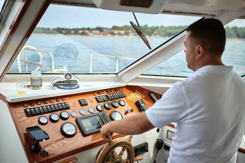 A man steering a boat with a wooden helm, various gauges, and a 'Captain' sign on the dashboard. 3
