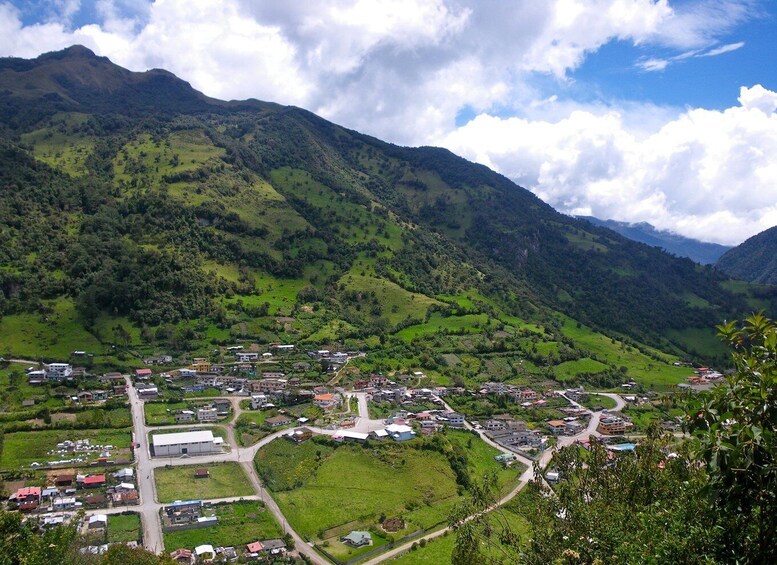 A mountainous landscape with a small town nestled in the valley. 2