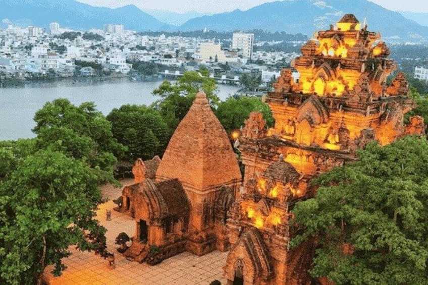 A temple with intricate architecture, a river in the background, and a cityscape. 1