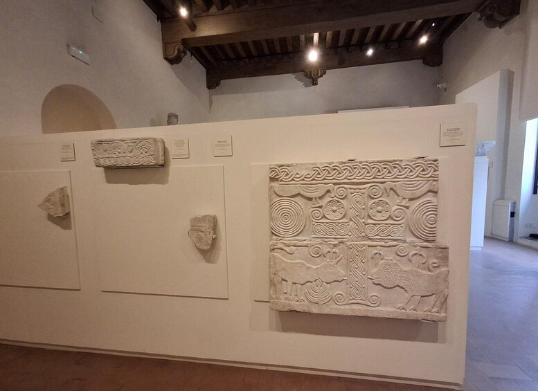 A museum display with ancient artifacts and detailed carvings. 5