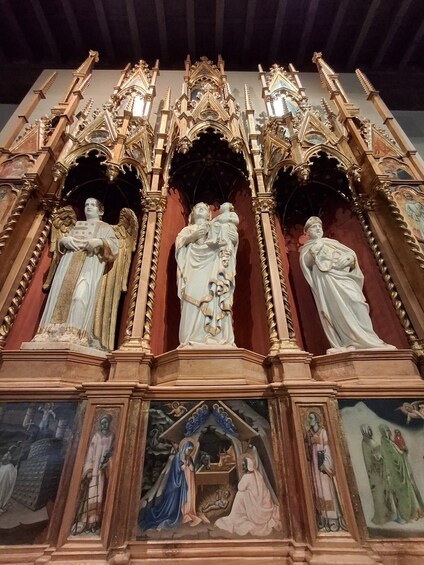 A detailed religious altar with statues and paintings. 1