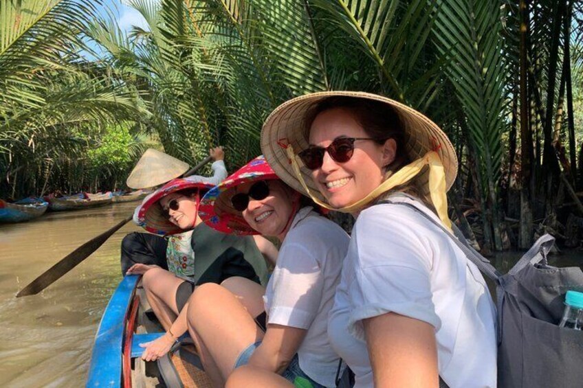 People on a boat in a tropical setting with palm trees. 3