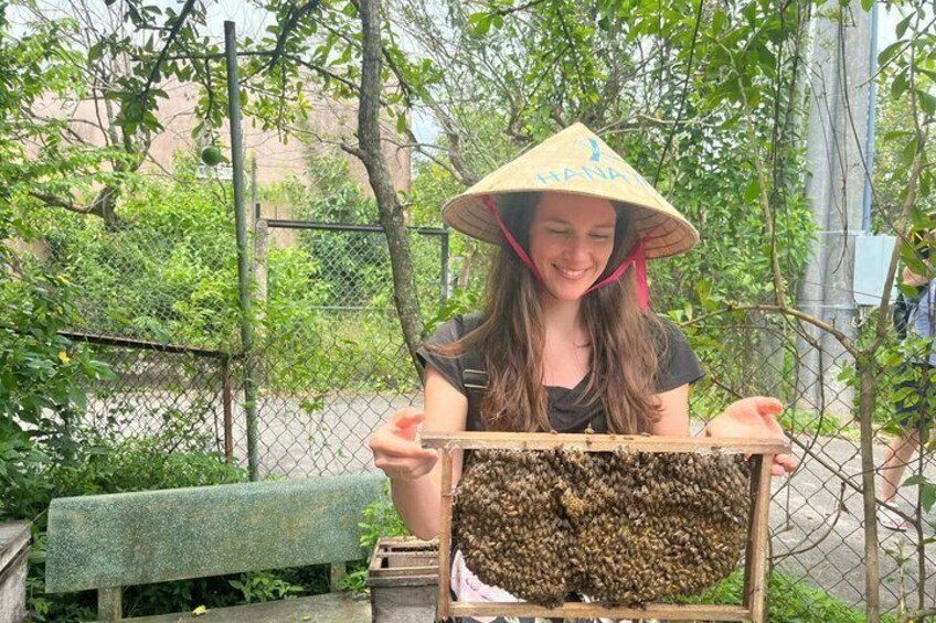 A person holding a beehive. 4