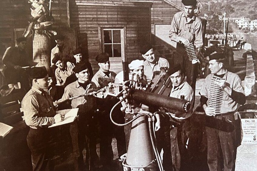 A group of people in a workshop setting, working with machinery and tools. 4