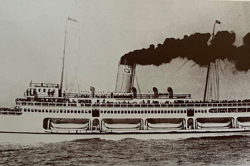 A large riverboat with multiple decks and smokestacks emitting smoke. 3
