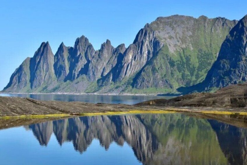 A mountain range with a lake reflecting its peaks. 5