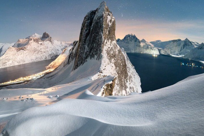 A snow-covered mountain peak, a glacier, and a fjord. 3
