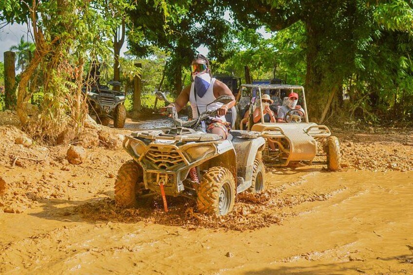 Off-road vehicles on a muddy path surrounded by trees. 5