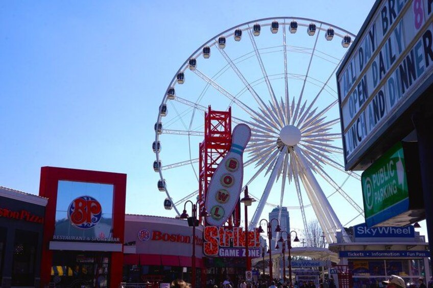 A Ferris wheel, a Boston Pizza restaurant, and a SkyWheel attraction. 3