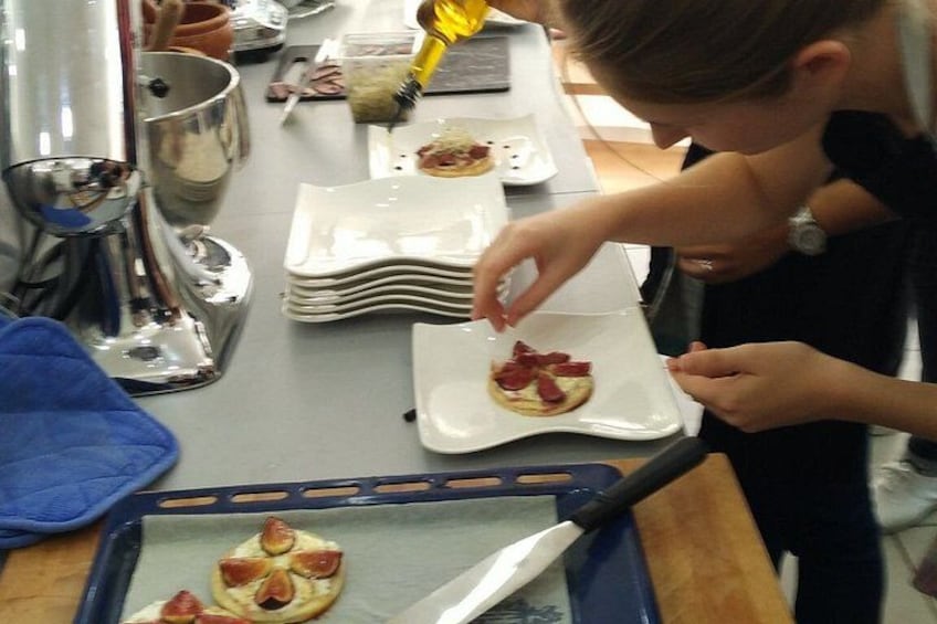 A person preparing food, specifically arranging slices of meat on a plate. 3